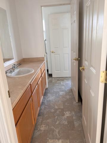 Upstairs sink area with doorway to bathroom